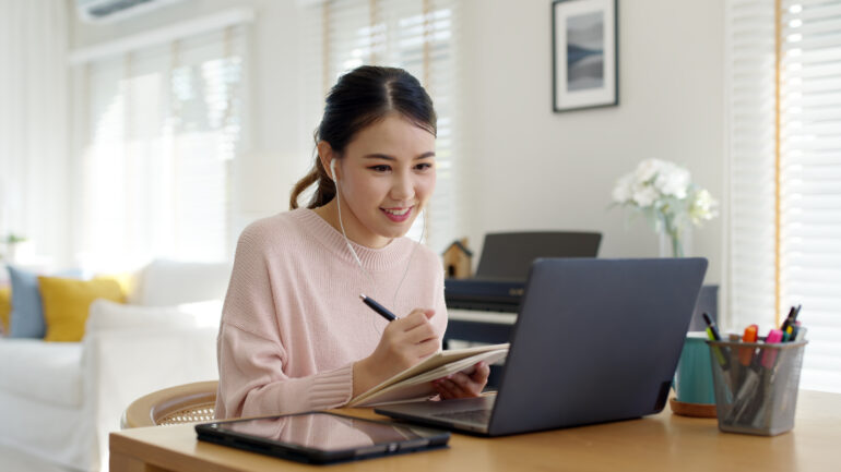 Asian woman at laptop prepping for her ABPN Psychiatry Board Exam